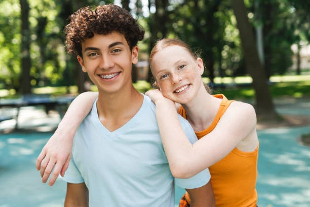 Two smiling teenagers outdoors